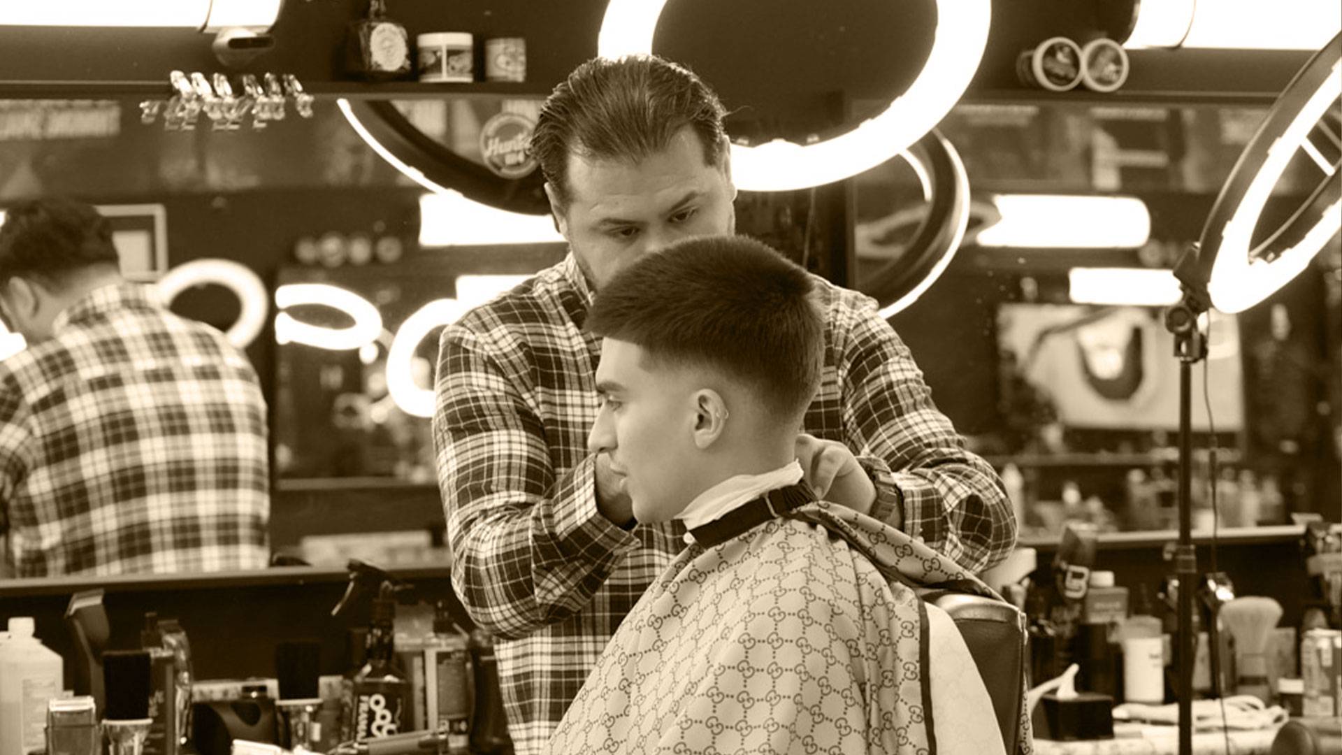 Barber working on a fade haircut - Made Men Studios